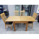 A SOLID OAK EXTENDING DINING TABLE WITH FOLD OVER MECHANISM 160.5 X 73 X 80CM TOGETHER WITH FOUR OAK