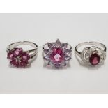 THREE SILVER AND PINK STONE RINGS STAMPED SIZES R 1/2 AND U 14.9G GROSS