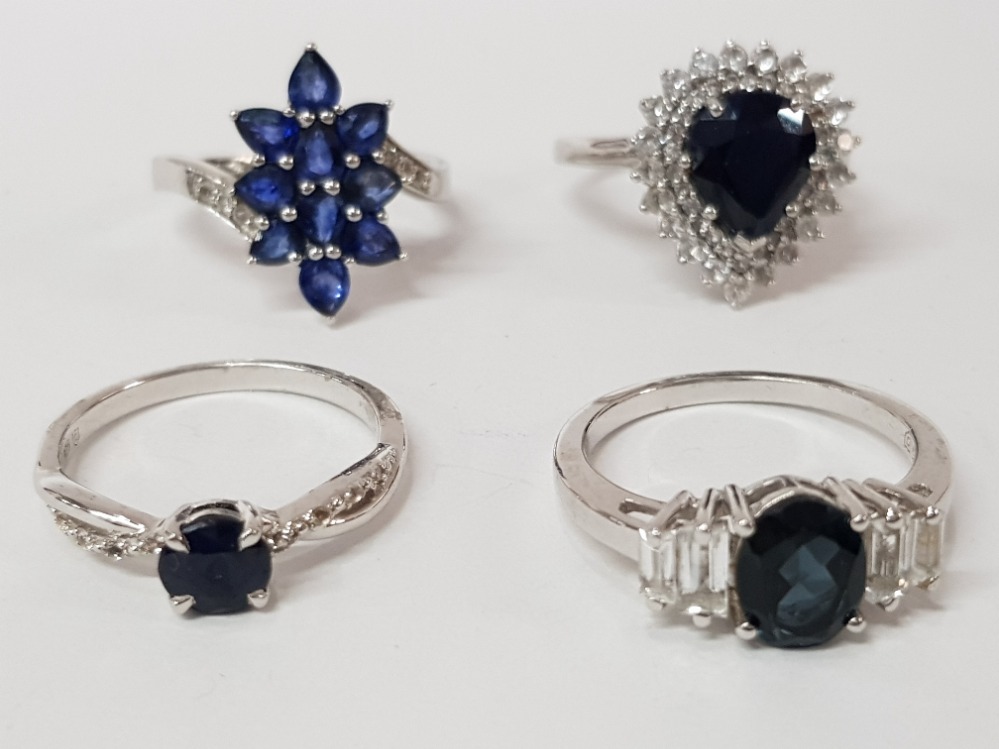 FOUR SILVER AND BLUE STONE RINGS STAMPED SIZES R 1/2 AND S 15.4G GROSS