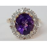 9CT YELLOW GOLD OVAL AMETHYST AND CUBIC ZIRCONIA CLUSTER RING, 5.1G SIZE Q1/2