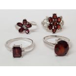 FOUR SILVER AND RED STONE RINGS STAMPED SIZES T T 1/2 AND U 16G GROSS