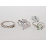 THREE SILVER RINGS OF VARIOUS DESIGNS STAMPED ONE WITH SHOP TAG SIZES R AND T 1/2 11.2G GROSS