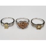 THREE SILVER AND YELLOW STONE RINGS STAMPED SIZES R 1/2 AND T 1/2 11.2G GROSS