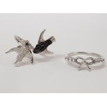 TWO SILVER WHITE AND BLACK STONE RINGS IN THE FORM BIRDS AND A BOW STAMPED SIZES P 1/2 AND T 1/2