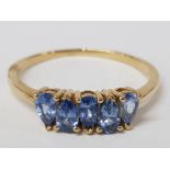 A 9CT YELLOW GOLD AND BLUE STONE RING T 1/2 2G GROSS