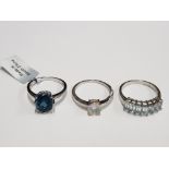 THREE SILVER BLUE AND OPAL STYLE RINGS STAMPED ONE WITH SHOP TAG SIZES R 1/2 T 1/2 AND U 9.4G GROSS