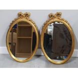 PAIR OF GILT FRAMED OVAL SHAPED MIRRORS, WITH BOW DESIGN TOP, 61 X 38CM