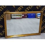 A MODERN BEVELLED WALL MIRROR IN GILT FRAME 100 X 70CM