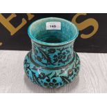 A JERUSALEM POTTERY VASE IN THE IZNIK STYLE BLACK FLORAL DECORATION ON BLUE GROUND STAMPED 15 CM