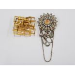 A GEOMETRIC GOLD COLOURED BROOCH AND A FAUX PEARL AND DIAMANTE DROP BROOCH