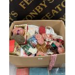A BOX CONTAINING UNUSED WOOL AND VARIOUS FABRICS