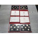 4 ROYAL MINT RED LEATHER DE LUXE CASED PROOF SETS DATING 1985 1986 1987 AND 1988 ALL IN ORIGINAL