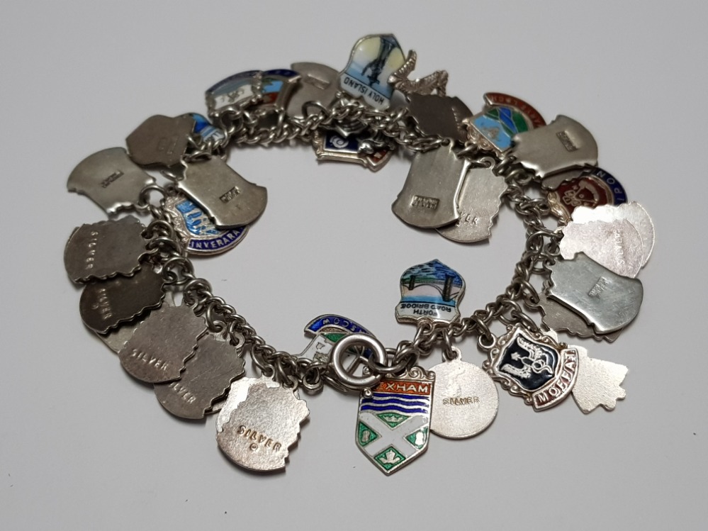 A SILVER BRACELET WITH APPROX 40 SILVER SOUVENIR SHIELDS 57.4G GROSS