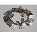 A SILVER BRACELET WITH APPROX 40 SILVER SOUVENIR SHIELDS 57.4G GROSS