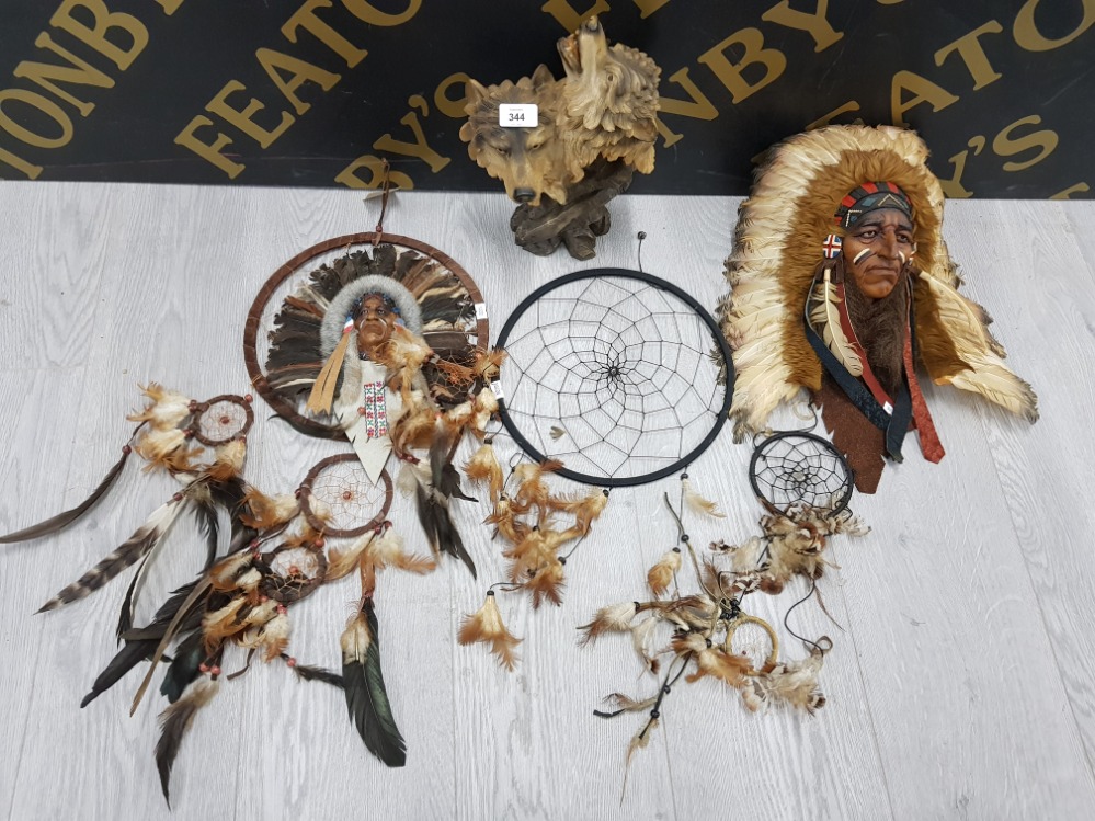 A RESIN SCULPTURE OF TWO WOLVES A NATIVE AMERICAN WALL PLAQUE AND THREE DREAM CATCHERS