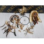 A RESIN SCULPTURE OF TWO WOLVES A NATIVE AMERICAN WALL PLAQUE AND THREE DREAM CATCHERS