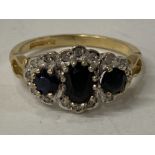 9CT YELLOW GOLD BLACK SAPPHIRE AND DIAMOND CLUSTER RING COMPRISING OF AN OVAL SAPPHIRE STONE SET