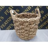 A LARGE TWIN HANDLED WICKER BASKET 54CM BY 58CM