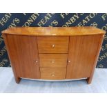 A BOW FRONTED VENEERED SIDEBOARD WITH METAL HANDLES THREE DRAWERS FLANKED BY CUPBOARD DOORS