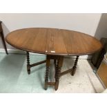 A VINTAGE OAK GATELEG DINING TABLE WITH FOUR UPHOLSTERED CHAIRS BY OLD CHARM