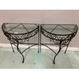 A PAIR OF METAL AND GLASS DEMI LUNE TABLES 62 X 76 X 32.5CM