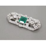 PLATINUM DIAMOND AND EMERALD ORNATE BROOCH COMPRISING 4CT PRINCESS CUT EMERALD AND 6CT CLUSTER OF
