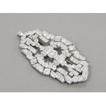 PLATINUM DIAMOND SET ORNATE BROOCH APPROXIMATELY 9CT IN TOTAL COMPRISING 2 EMERALD CUT DIAMONDS