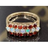A 9CT YELLOW GOLD OPAL AND GARNET RING SIZE N 3.3G GROSS