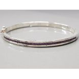 A SILVER AND AMETHYST BANGLE STAMPED 925 27G GROSS