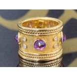 AN 18CT YELLOW GOLD AMETHYST AND DIAMOND TEMPLER BAND RING BY ELIZABETH GAGE SET WITH FOUR AMETHYSTS