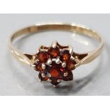 A 9CT YELLOW GOLD AND NINE STONE GARNET CLUSTER RING SIZE P 1/2 1.4G GROSS