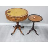 A MAHOGANY BROWN LEATHER TOPPED DRUM TABLE WITH BRASS CLAW CASTORS TOGETHER WITH MAHOGANY BROWN