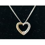 A 9CT WHITE AND YELLOW GOLD DIAMOND SET HEART SHAPED PENDANT ON 9CT WHITE CHAIN 2.1G GROSS