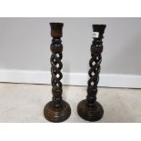 A PAIR OF OAK CANDLESTICKS WITH TWISTED COLUMNS AND BRASS DRIP TRAYS 45CM HIGH