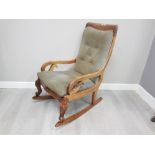 A MAHOGANY FRAMED UPHOLSTERED EDWARDIAN ROCKING CHAIR WITH CABRIOLE SUPPORT