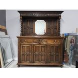 AN OAK DRESSER BY COUNTRY FORM BEVELLED MIRROR BACK FLANKED BY BARLEY TWIST SUPPORTS TWO DRAWERS