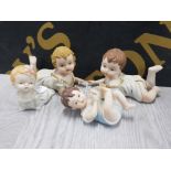 4 BISQUE POTTERY PIANO BABIES