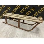 A VINTAGE WOODEN AND METAL SLEDGE 92CM LONG