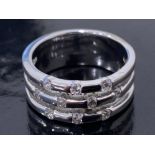A 14CT WHITE GOLD AND DIAMOND FANCY BAND SET WITH .35CTS BRILLIANT CUT DIAMONDS, SIZE K 1/2 7.3G