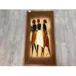 AN AFRICAN BATIK BY J OCHIENG THREE MASAI WOMEN HOLDING SPEARS SIGNED 83 X 41CM