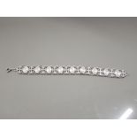 FULLY HALLMARKED SILVER BRACELET WITH LINKS OF STARBURST SHIELDS INTERSPACED WITH OVAL CROSSES 7