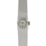 A diamond cocktail watch.Estimated total diamond weight 0.15ct.Stamped 750.Length 18.5cms.