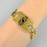 An early 20th century 18ct gold calibre-cut sapphire floral panel bracelet.Stamped Depose, 18k.