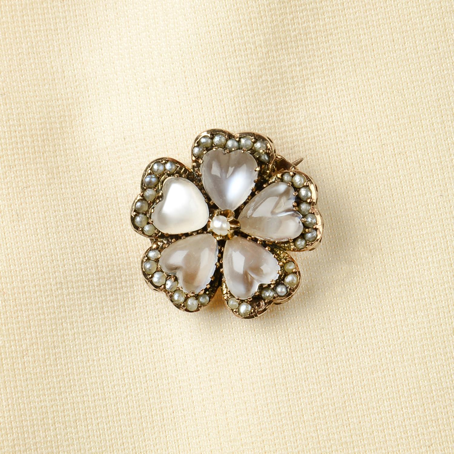 An Edwardian gold moonstone and split pearl floral brooch.Diameter 2cms.