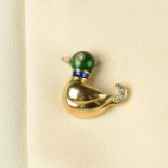 A diamond and enamel duck pin, by Cartier.Stamped 750.