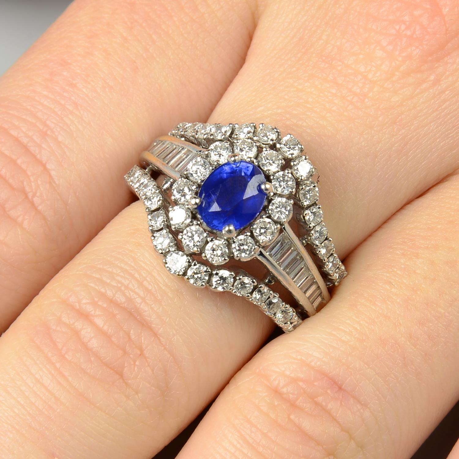 A sapphire and diamond cluster dress ring.