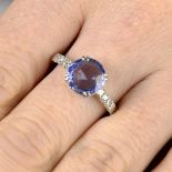 A Sri Lankan sapphire single-stone ring, with diamond line shoulders.