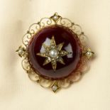 An early 20th century 15ct gold garnet brooch,