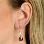 A pair of natural pearl and orange zircon earrings.With report 265008/20046282,