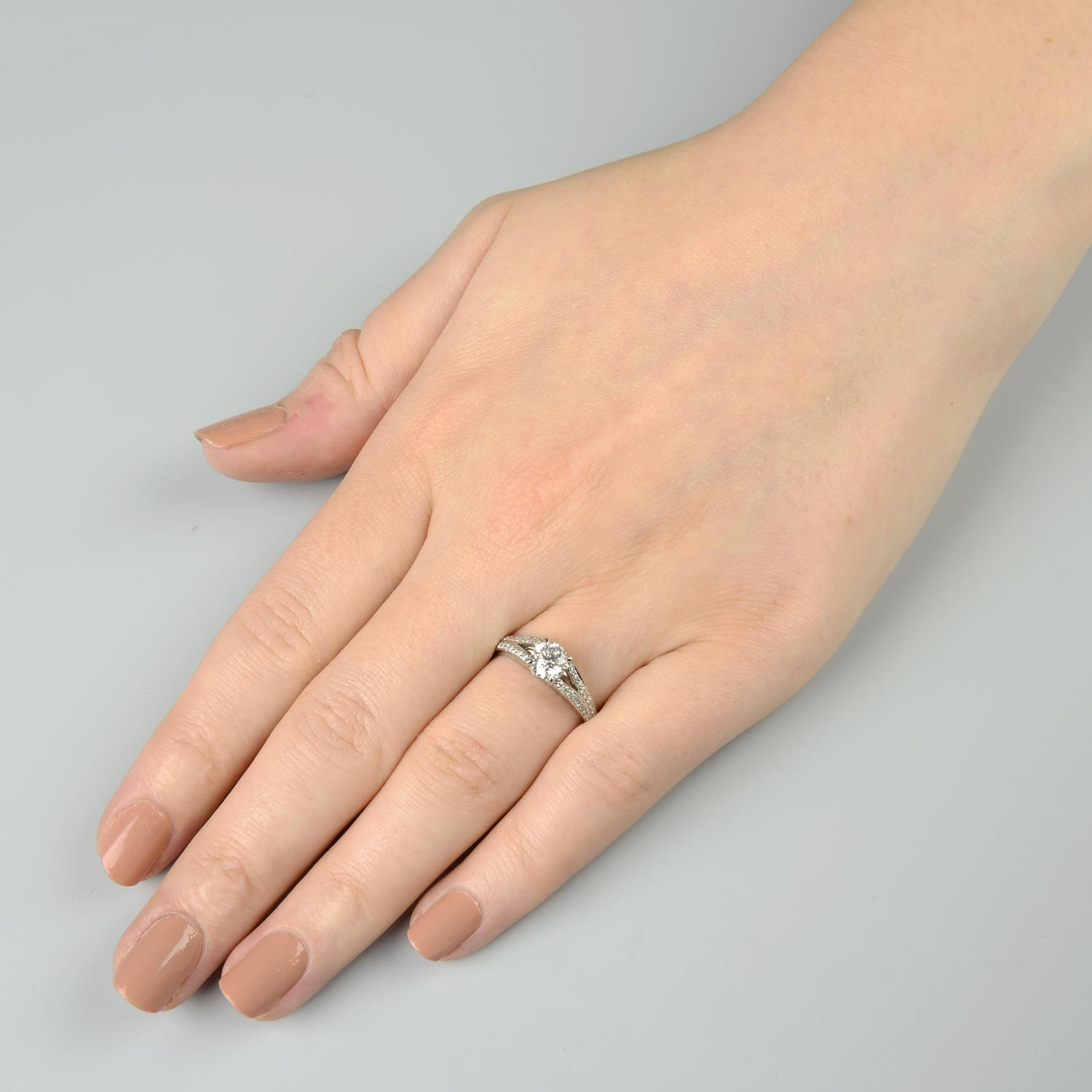 A platinum brilliant-cut diamond single-stone ring, with diamond chevron shoulders. - Image 3 of 6